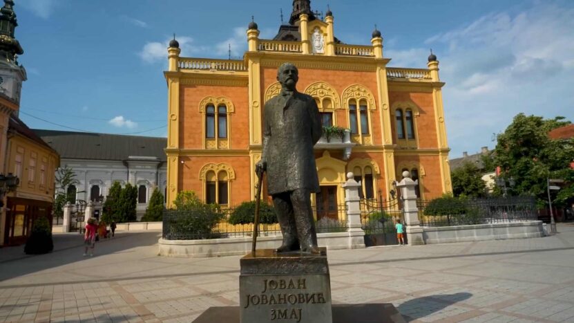 The statue of Serbian poet Jovan Jovanović Zmaj stands in front of the Bishop's Palace in Novi Sad's historic center.